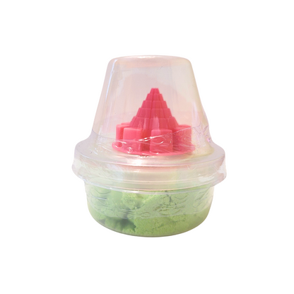 A container of green sensory sand and a pink conical castle mold.