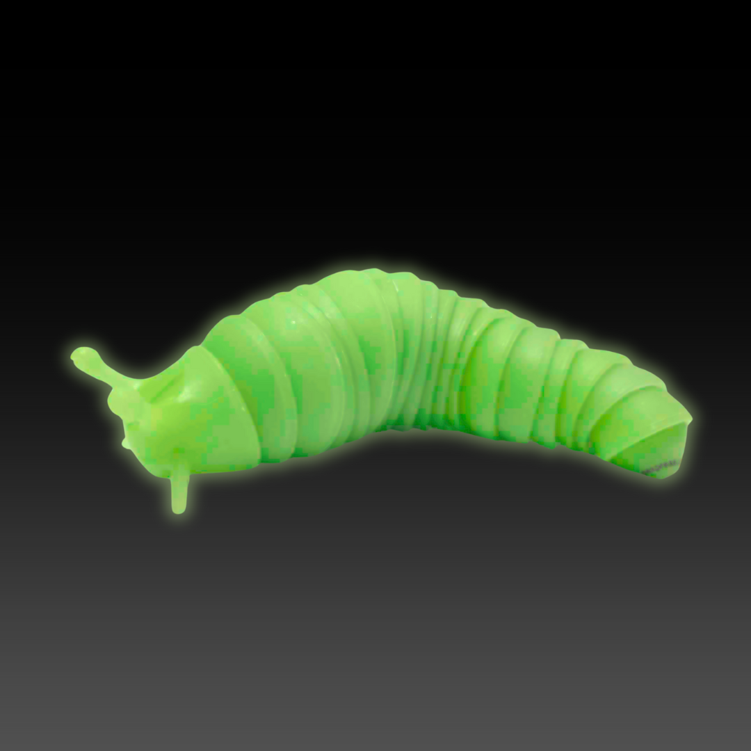 A lime green Super Sensory Glow-in-the-Dark Fidget Slug glowing in the dark.