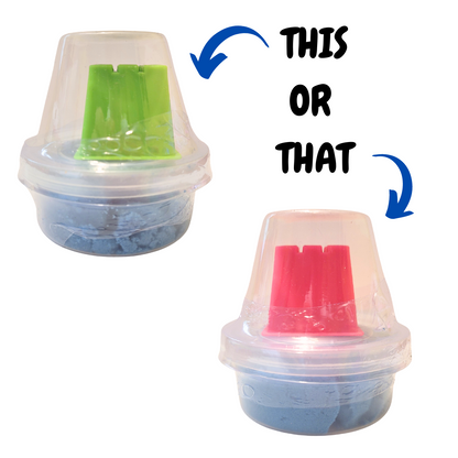 Text reads "This or That" with arrows. The arrow for "This" points to a container of blue sensory sand with a green rectangular castle mold. The arrow for "That" points to a container of blue sensory sand with a pink rectangular castle mold.
