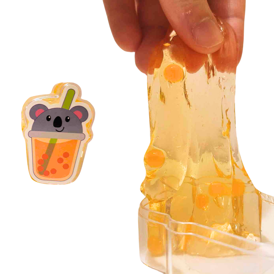 On the left is a picture of the koala themed Boba Tea Inspired Slime. On the right, larger, a person's hand stretches the slime out of the container upward into the air.