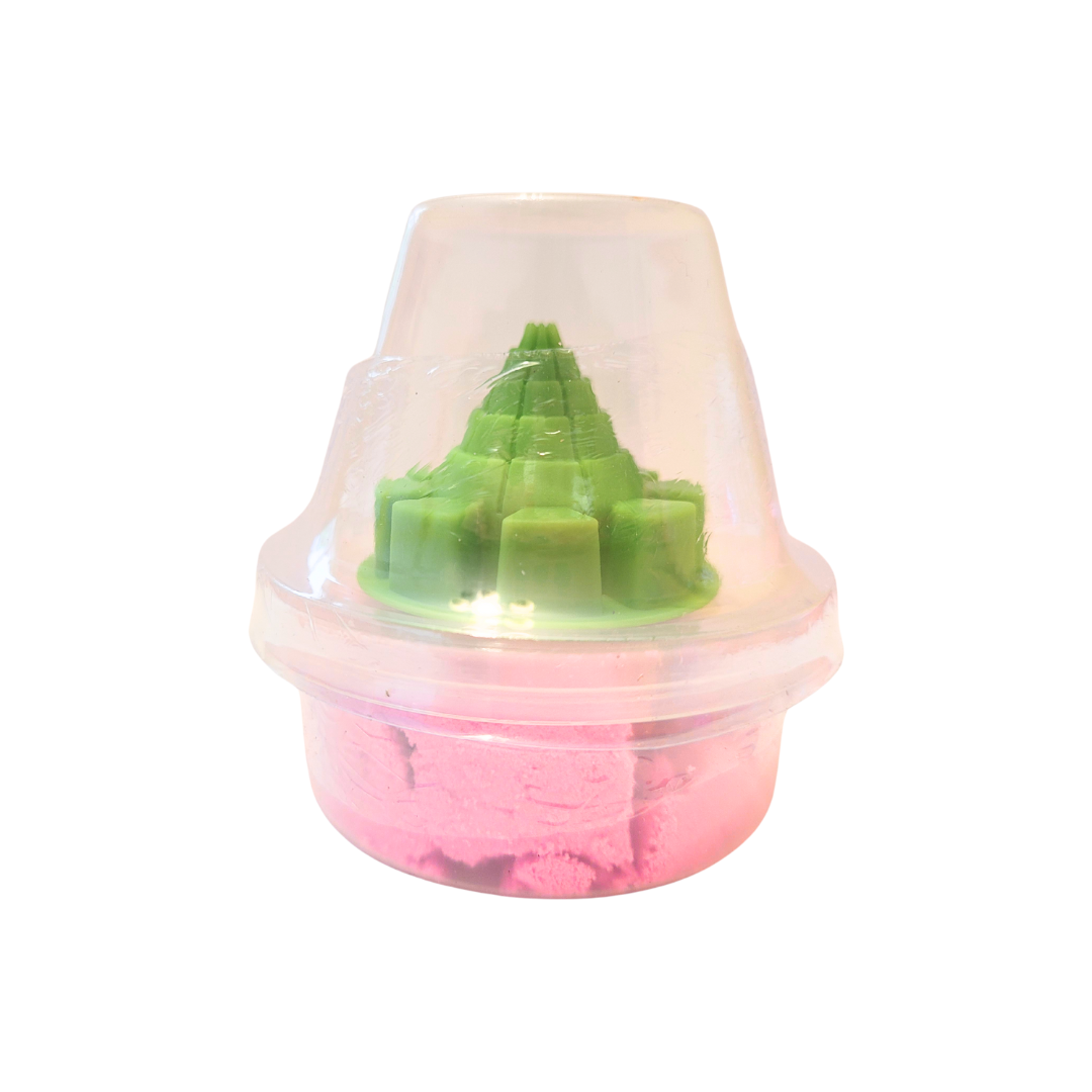 A container of pink sensory sand with a green conical castle mold.