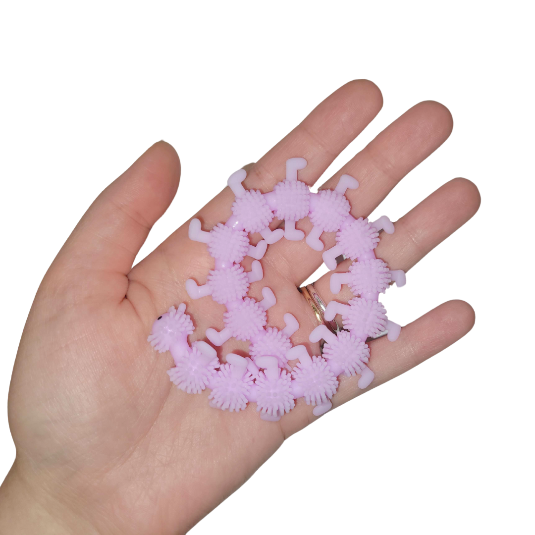 A person's hand holds out a lavender stretchy catepillar.