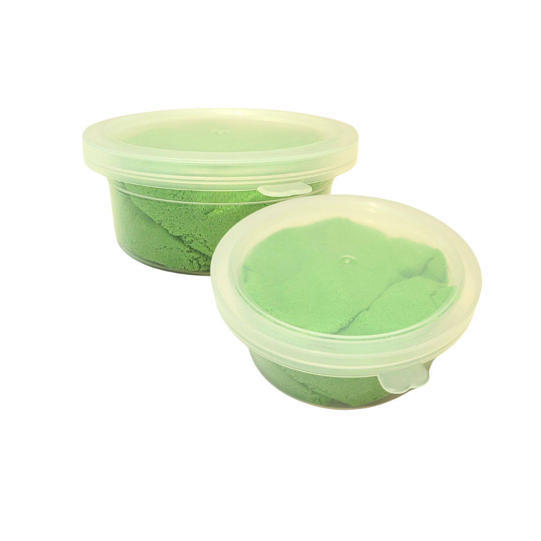 Two containers of green Sticky Sand.