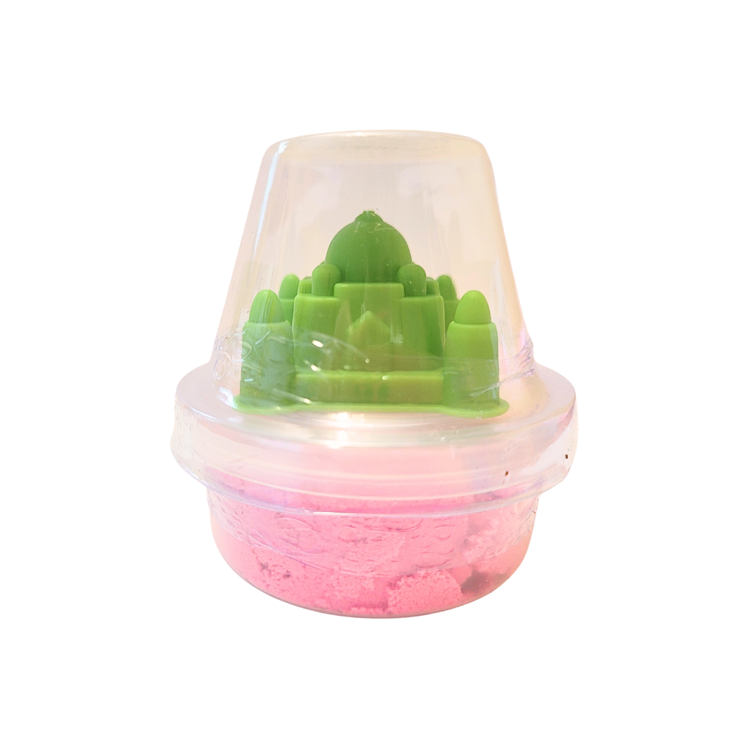 A container of pink sensory sand with a green Taj Mahal inspired castle mold.