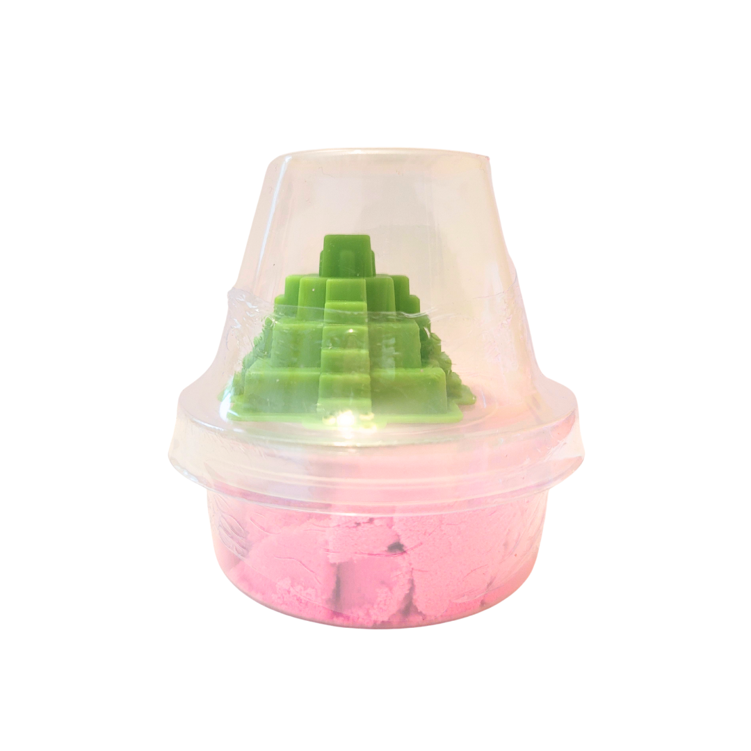 A container of pink sensory sand with a green Chichen Itza inspired castle mold.