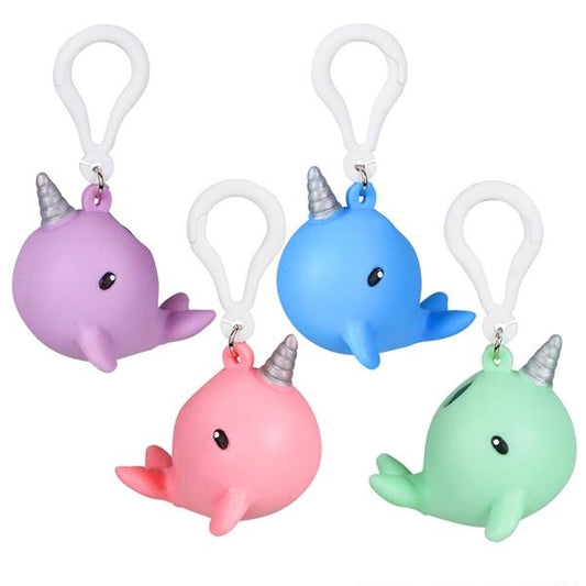 Four squishy narwhal keychains. From left to right, they are purple, pink, blue, and green.