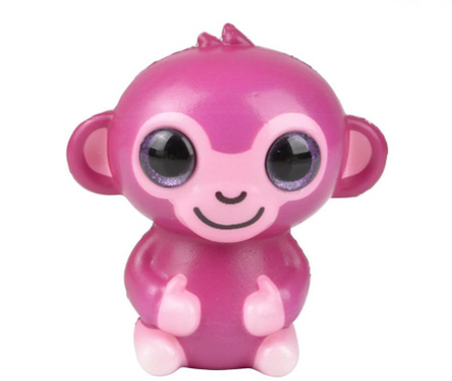 A Monkey Sparkle Eye Slow Rise Squishy. The Monkey is fuschia with pink accents and lavender eyes.