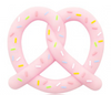 A pink pretzel handheld chewable, with sprinkles in lime green, white, pink, blue, and yellow.