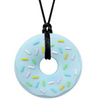 Blue Donut chewable necklace with white, pink, green, blue, and yellow sprinkles